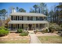 Traditional two-story house with covered front porch and walkway at 959 Hampton Nw Trl, Lilburn, GA 30047