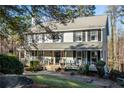 Traditional two-story home with a charming covered front porch and mature trees at 959 Hampton Nw Trl, Lilburn, GA 30047