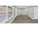 An open floorplan features hardwood flooring, neutral walls, and lots of light at 2478 Verbena Nw Cir, Atlanta, GA 30314