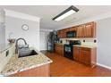Well-equipped kitchen with wood cabinets, stainless steel appliances, and granite countertops at 2845 Englewood Dr, Cumming, GA 30040