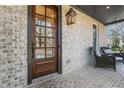 Welcoming front porch featuring brick flooring, a stylish front door, and comfortable seating at 2620 Middle Coray Cir, Marietta, GA 30066