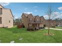 Spacious backyard with lush green grass, mature trees, and a view of the home's exterior at 3400 Palmer Lake Pointe, Douglasville, GA 30135