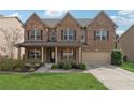 Beautiful brick home with manicured lawn, inviting front porch, and attached two-car garage, exuding curb appeal at 3400 Palmer Lake Pointe, Douglasville, GA 30135