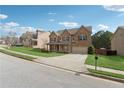 Charming two-story brick home with a well-manicured lawn, mature landscaping, and a welcoming front porch at 3400 Palmer Lake Pointe, Douglasville, GA 30135
