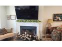 Cozy living room with fireplace, mantle, and stylish decor at 188 Foxtail Rd, Woodstock, GA 30188