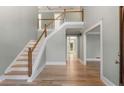 Inviting foyer with hardwood floors, staircase, and high ceilings at 3672 Howell Wood Nw Trl, Duluth, GA 30096