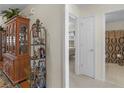 Hallway with neutral walls and wood floors and views to bathroom and bedroom at 507 Mockingbird Ln, Loganville, GA 30052