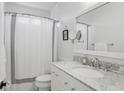 This bathroom has white cabinets, white marble countertops, and tiled walls at 907 Piedmont Ne Ave # 7, Atlanta, GA 30309