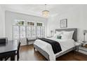 This spacious bedroom features a decorative screen in front of the windows and wood flooring at 907 Piedmont Ne Ave # 7, Atlanta, GA 30309