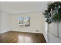 Bright living room featuring hardwood floors, a large window and fresh, white paint at 1989 Mount Vernon Rd, Atlanta, GA 30338