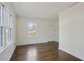 Bright living room featuring hardwood floors, a large window and fresh, white paint at 1989 Mount Vernon Rd, Atlanta, GA 30338