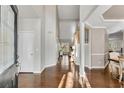 Welcoming foyer with hardwood floors, high ceilings, and natural light streaming through the doorway at 3015 Foxhall Overlook, Roswell, GA 30075