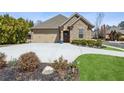 Beautifully landscaped front yard with a wide driveway leading to a two-car garage at 1358 Magnolia Path Way, Sugar Hill, GA 30518