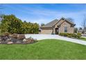Inviting front yard with lush green grass and landscaped garden beds at 1358 Magnolia Path Way, Sugar Hill, GA 30518