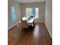 Inviting dining room with hardwood floors, large windows, and ample natural light perfect for Gathering gatherings at 224 Crest Creek Way, Villa Rica, GA 30180