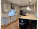 Modern kitchen featuring stainless steel appliances, granite countertops, and a stylish island with bar seating at 224 Crest Creek Way, Villa Rica, GA 30180