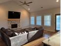 Cozy living room with fireplace, vaulted ceiling, and ample natural light, perfect for relaxing and entertaining at 224 Crest Creek Way, Villa Rica, GA 30180