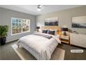 Cozy bedroom with a large window, soft lighting, and neutral decor at 1182 Tupelo Chase Ct, Auburn, GA 30011
