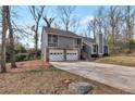 View of the house showcasing the two-car garage and inviting facade at 1575 Kelleys Close, Stone Mountain, GA 30088