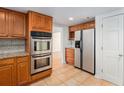 Kitchen view of stainless double oven and fridge along with plentiful cabinet space at 320 Six Branches Ct, Roswell, GA 30076