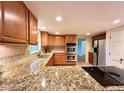 This kitchen boasts granite countertops, stainless steel appliances and tile backsplash at 320 Six Branches Ct, Roswell, GA 30076