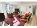 This beautifully appointed living room features hardwood floors, a large window, and elegant furnishings at 300 Peachtree Ne St # 24F, Atlanta, GA 30308