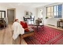 The open concept living room boasts a decorative rug, hardwood flooring, and lots of natural light at 300 Peachtree Ne St # 24F, Atlanta, GA 30308