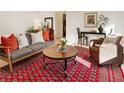 Inviting living room featuring cozy seating, a stylish rug, and a seamless flow into the dining area at 300 Peachtree Ne St # 24F, Atlanta, GA 30308