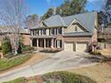 Elegant brick home featuring a two-car garage, well-kept landscaping, and traditional design elements at 4312 White Hickory Nw Ln, Kennesaw, GA 30152