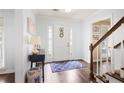 Bright foyer with hardwood floors, white trim, and staircase, creating a welcoming entrance at 6011 Fairlong Nw Ct, Acworth, GA 30101