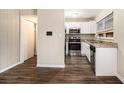 Cozy kitchen featuring stainless steel appliances, granite countertops, and dark wood-look flooring at 2131 Columbia Dr, Decatur, GA 30032