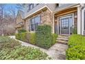 Inviting entryway with stone accents, lush landscaping, and a 'WELCOME' sign creating a warm and friendly ambiance at 2290 Dragonfly Nw Ct, Acworth, GA 30101