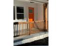 Charming front porch detail with an eye-catching orange front door at 2430 Hanford Sw Dr, Atlanta, GA 30315