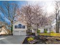 Charming two-story home featuring a well-manicured lawn and flowering tree, enhancing its curb appeal at 210 Barrett Springs Way, Canton, GA 30115