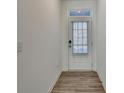 Bright entryway with wood-look floors and a door with window at 2054 Hickman Walk, Suwanee, GA 30024