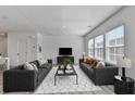Sun-filled living room with two sofas, large windows and modern decor at 2054 Hickman Walk, Suwanee, GA 30024