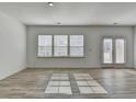 Bright and spacious living room features natural light and wood-look flooring at 2054 Hickman Walk, Suwanee, GA 30024