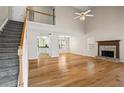 Spacious living room with hardwood floors, a fireplace, and access to the staircase at 55 Legend Creek Cove, Douglasville, GA 30134