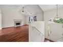 Open-concept living space boasting hardwood floors, vaulted ceiling, and ample natural light at 125 Fairhaven Trl, Fairburn, GA 30213