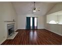Spacious living room with vaulted ceiling, fireplace, and large windows at 125 Fairhaven Trl, Fairburn, GA 30213