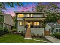 Modern two-story home with a covered porch, landscaped yard, and wooden steps leading to the entrance at 245 Mathewson Pl, Atlanta, GA 30314