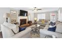 Comfortable living room featuring a cozy fireplace, plush seating, and lots of natural light at 3034 Bristlewood Nw Ln, Marietta, GA 30064