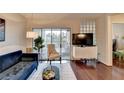 Bright living room with sliding glass doors to balcony, contemporary furniture, and sleek entertainment center at 275 13Th Ne St # 310, Atlanta, GA 30309