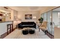 Stylish living room with hardwood floors, contemporary decor, and an open view of the kitchen and dining area at 275 13Th Ne St # 310, Atlanta, GA 30309