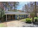 Beautiful exterior view of this home featuring a screened in porch, lovely paint colors, and mature landscaping at 621 Spruce Dr, Stone Mountain, GA 30083
