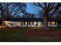 Exterior of the attractive white brick home featuring dark trim, decorative lattice, and manicured front lawn at 1199 Murray Sw Cir, Marietta, GA 30064