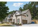 Two-story home featuring a side-entry garage, brick accents, and beautifully manicured landscaping at 1249 Austin Thomas Dr, Dacula, GA 30019