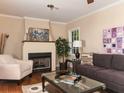 Cozy living room features a fireplace with white mantel, hardwood floors, and neutral paint at 2380 Strathmore Dr, Atlanta, GA 30324
