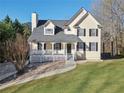 Two-story home with a welcoming front porch and well-maintained lawn at 274 Sleepy Hollow Rd, Powder Springs, GA 30127