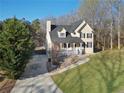 Charming two-story home with a welcoming front porch, driveway, and lawn at 274 Sleepy Hollow Rd, Powder Springs, GA 30127